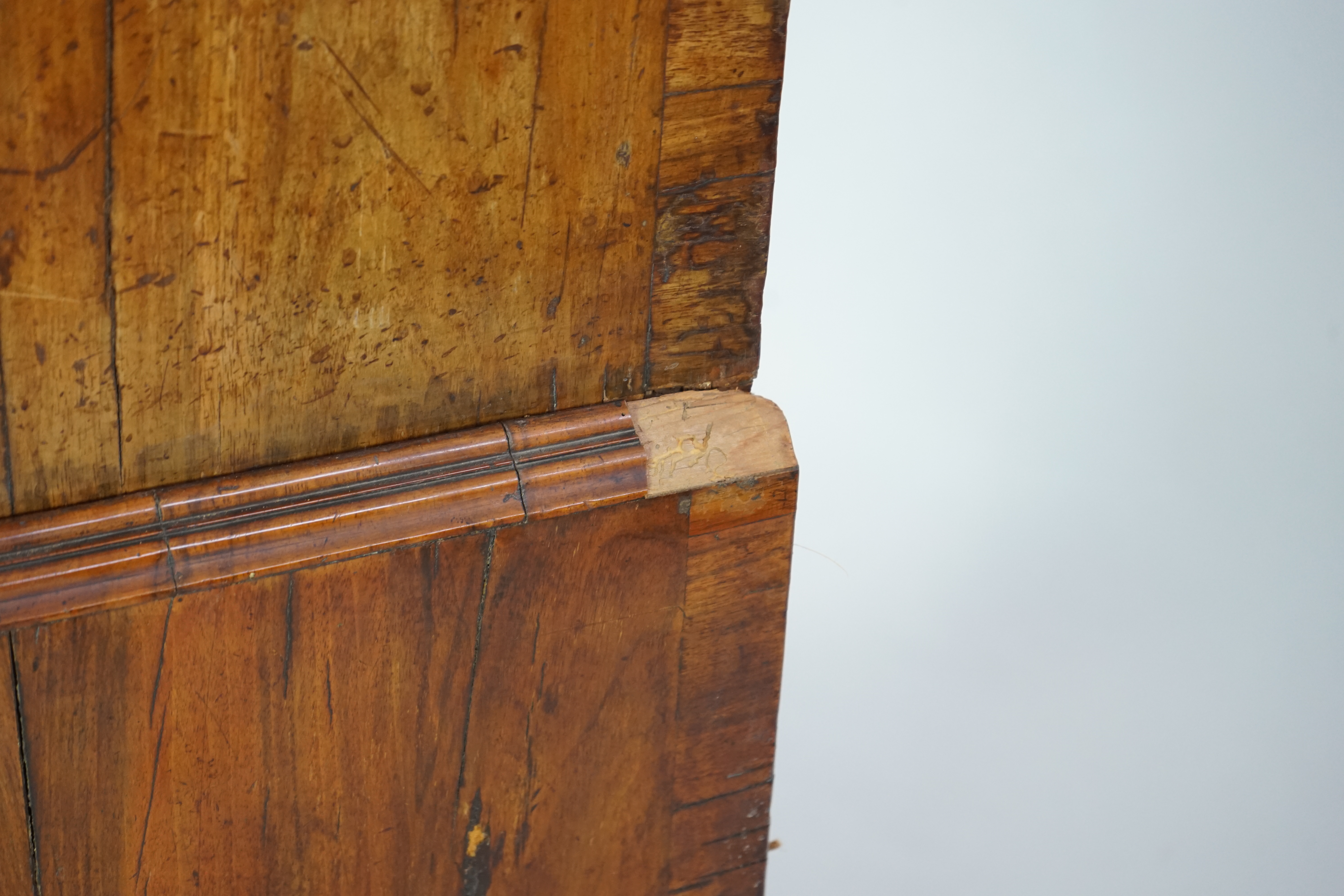 A George II feather banded walnut chest on chest